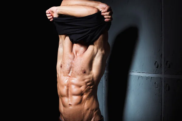 Young man with perfect body stripping — Stock Photo, Image