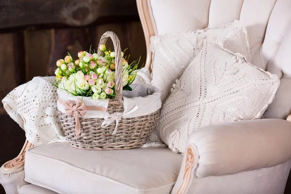 Basket with tulips on vintage chair — Stock Photo, Image