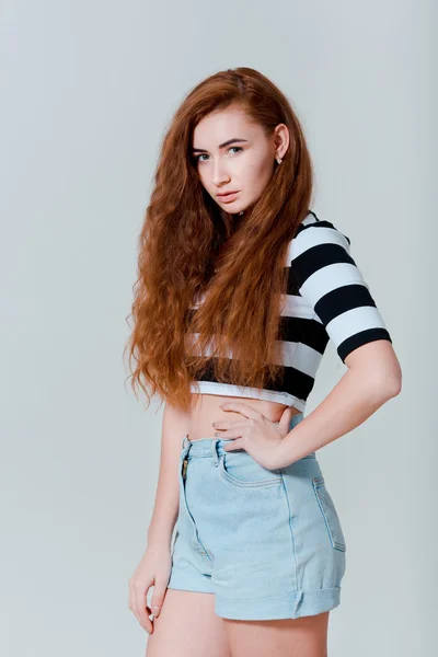 Portrait of beautiful sexy young rude girl in jeans shorts — Stock Photo, Image