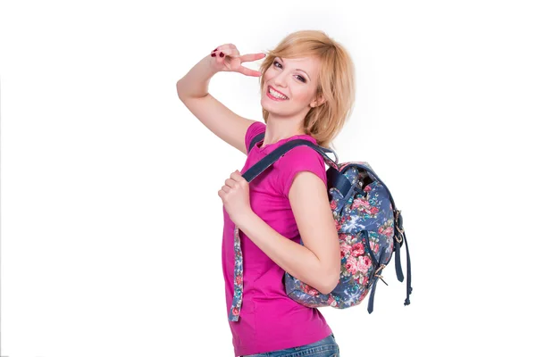 Student szczęśliwy dziewczynka z plecakiem, uśmiechając się i podejmowania gest kamyk. Na białym tle — Zdjęcie stockowe