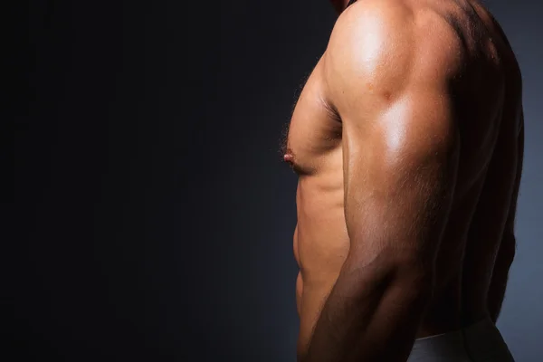 Мускулистый и здоровый туловище молодого спортсмена показывает свои идеальные мышцы трицепса — стоковое фото