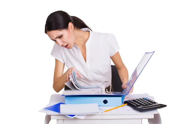 Young business woman sitting stressed in office with a lot of paperwork. People overworked. Headache at work — Stock fotografie