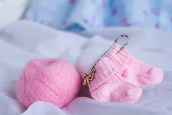 Pretty pink woolen baby socks on white background — Stock Fotó