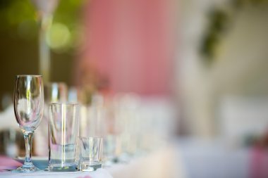 Three empty glasses on banquet table in restaurant