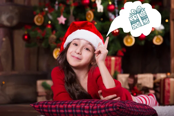 Beautiful Santa girl dreaming near the Christmas tree, making a wish. New year atmosphere — Stock fotografie