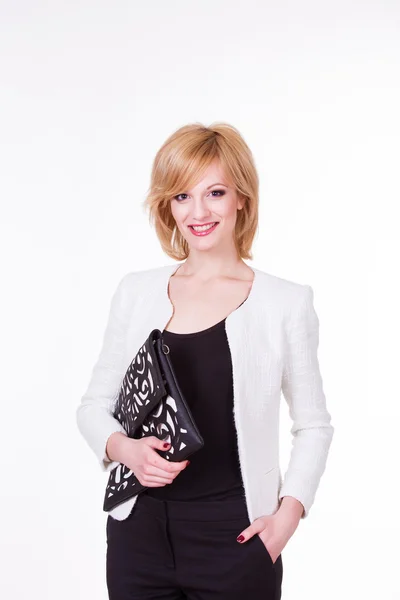Beautiful sexy young female in fashion clothes posing with black bag on white background — ストック写真