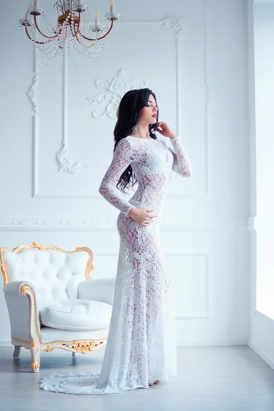 Perfetto, gambe sexy e culo di giovane donna che indossa seducente abito bianco posa vicino sedia vintage di lusso — Foto Stock
