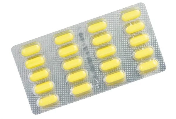 Comprimido amarillo en blíster Fotos de stock