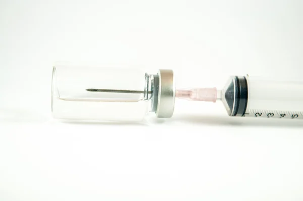 Closed up needle put in vial — Stock Photo, Image