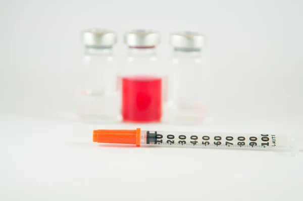 Disposable syringe and injection vials background — Stock Photo, Image