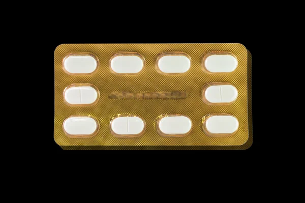Comprimé blanc en plaquette thermoformée dorée — Photo