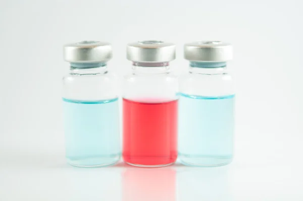 Красная и синяя жидкость во флаконах для инъекций — стоковое фото