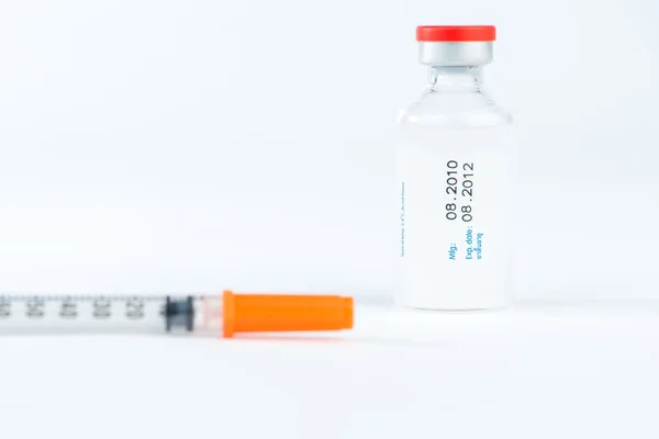 Injection vial and blur of injection syringe — Stock Photo, Image