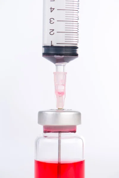 Injection syringe put in medicine vial — Stock Photo, Image