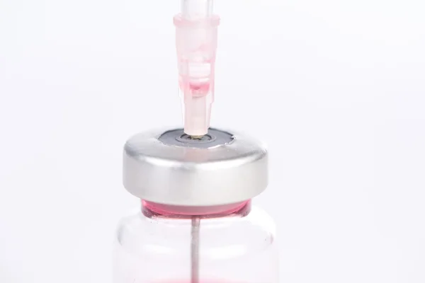 Injection syringe put in medicine vial — Stock Photo, Image