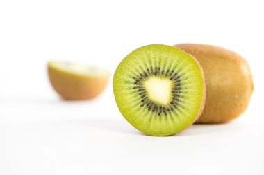 Sliced and cut kiwi fruit on white