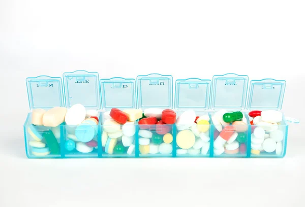 Medicine tablet and capsule in weekly pill box — Stock Photo, Image