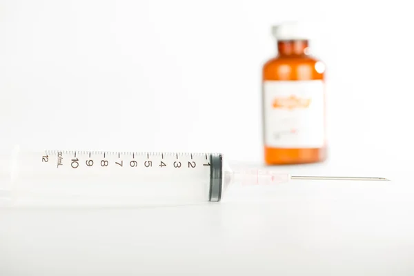Injection syringe and brown ampule — Stock Photo, Image