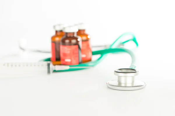 Stethoscope with bottles of injection medicine — Stock Photo, Image