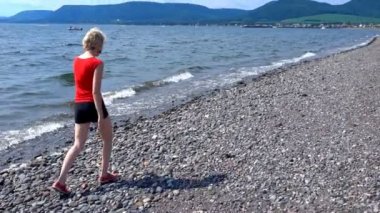 Gaspe, deniz kıyısında yürüyen kadın 