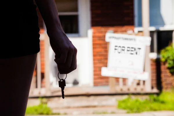 Unge kvinne står foran sin nye leilighet – stockfoto