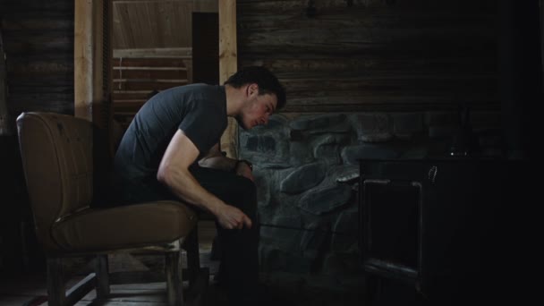 Man Relaxing in front of Burning Stove — Stock Video