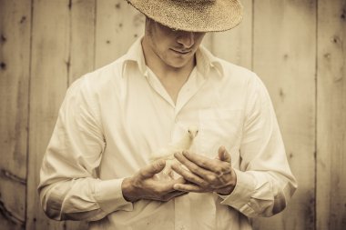 Farmer Holding a Baby Turkey clipart