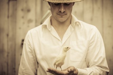 Farmer Holding a Baby Turkey clipart