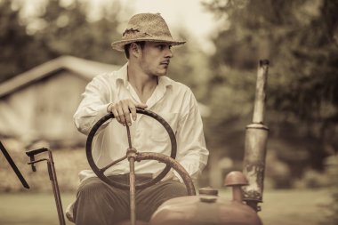 Young Farmer on a Vintage Tractor clipart
