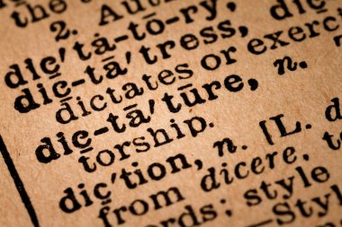 Close-up of an Opened Dictionary showing the Word DICTATURE