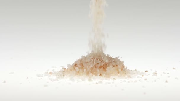 Super slow motion Himalayan salt faller på vit bakgrund — Stockvideo