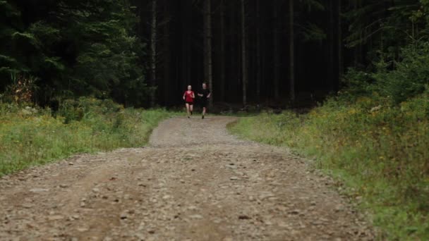 Couple Running on a Gravel Road — Stock Video