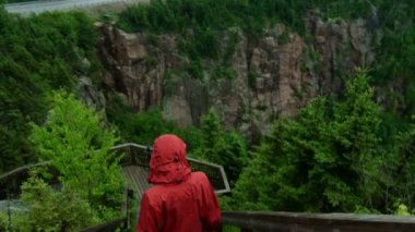 Woman Walking down the Stairs of a Mountain Boardwalk