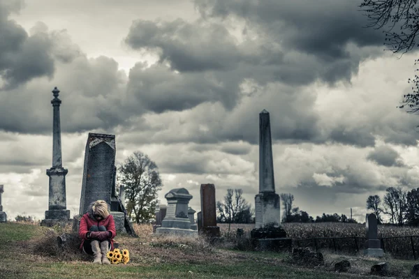 Donna con girasoli in un cimitero — Foto Stock