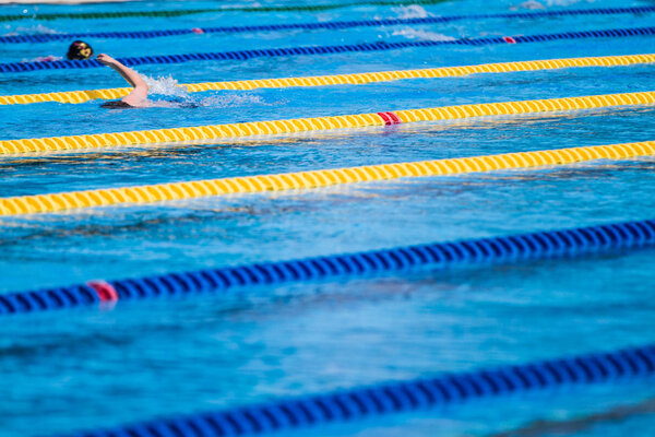 Swimmers Warming-up in the morning and doing a few Pool distance