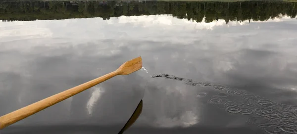 Su damlayan kürek Ormanı yansıtan su.