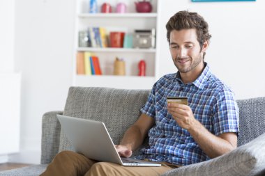 adam alışveriş dizüstü bilgisayar kullanarak