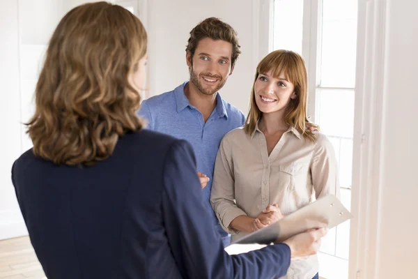 Junges Paar besucht Wohnung mit Immobilienmakler — Stockfoto