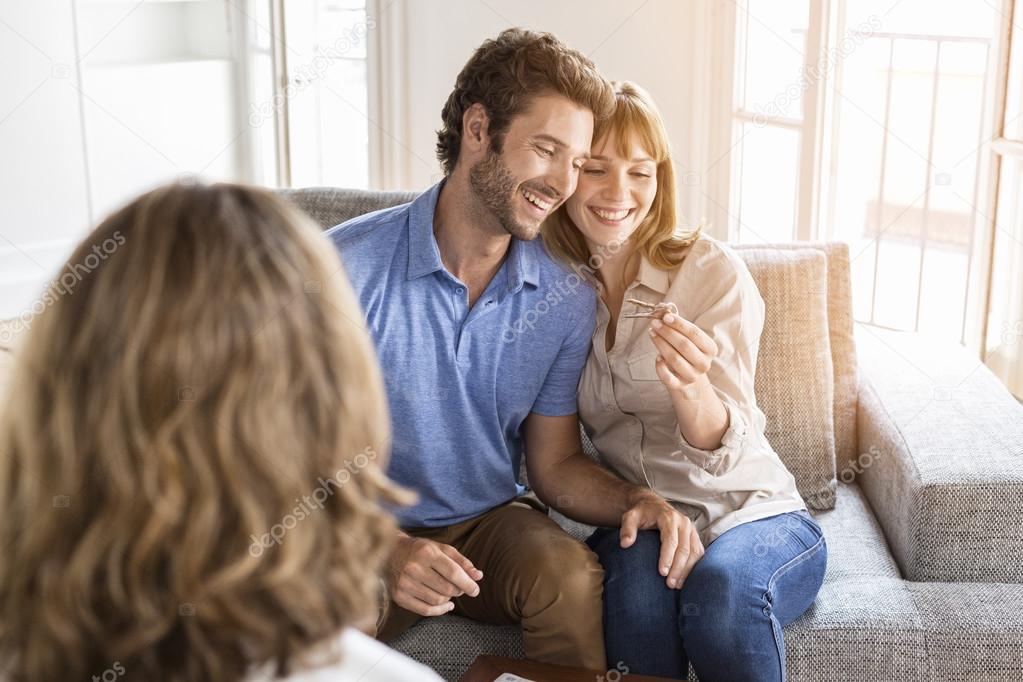 Saleswoman giving apartment keys to new owners