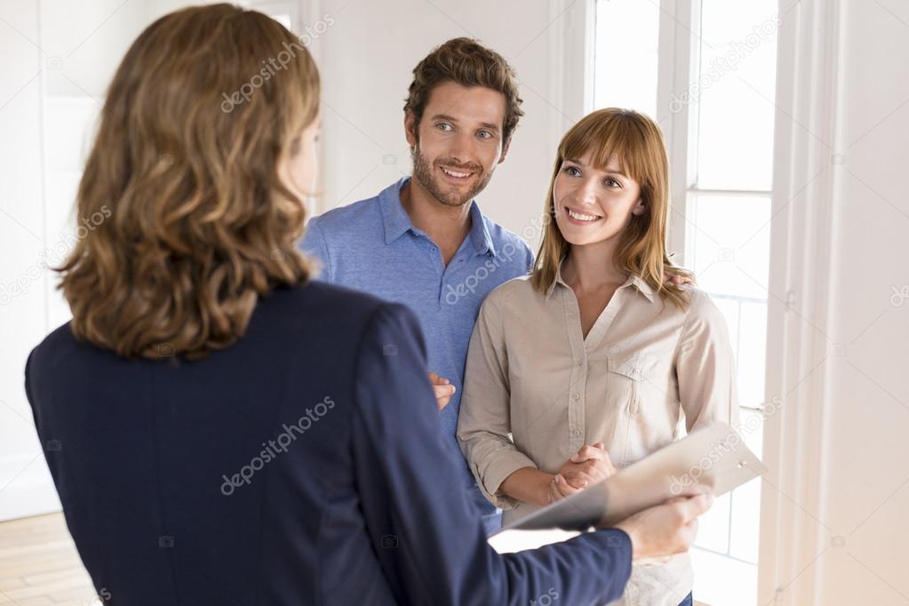 Young couple visiting apartment with real estate agent