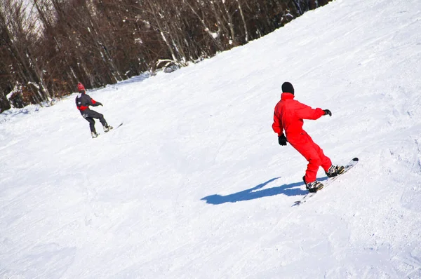 Two Mens Riding Snowboard Two Mens Bright Costumes Riding Snowboard — Stock Photo, Image