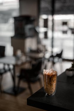 Yakın plan buzlu kahve. Masada süt var.