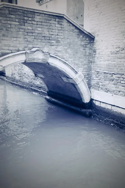 Old water channel with arch bridge in retro style — Stock Photo, Image