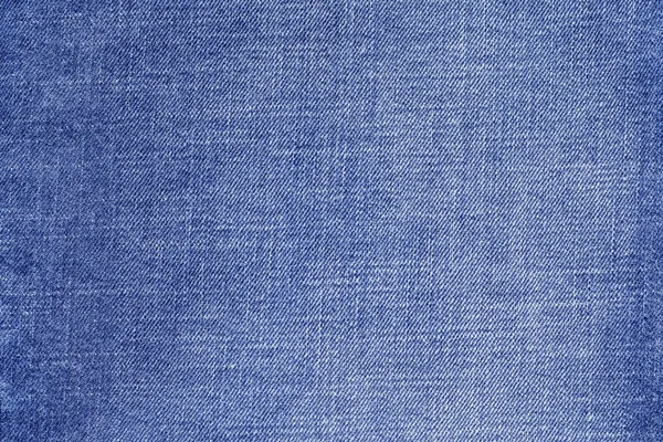 Texturerat bakgrund från denim av blek blå färg — Stockfoto