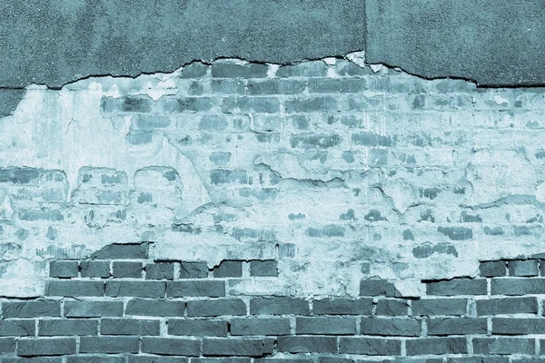 Texture of an old blue brick wall with destroyed plaster — Stock Photo, Image