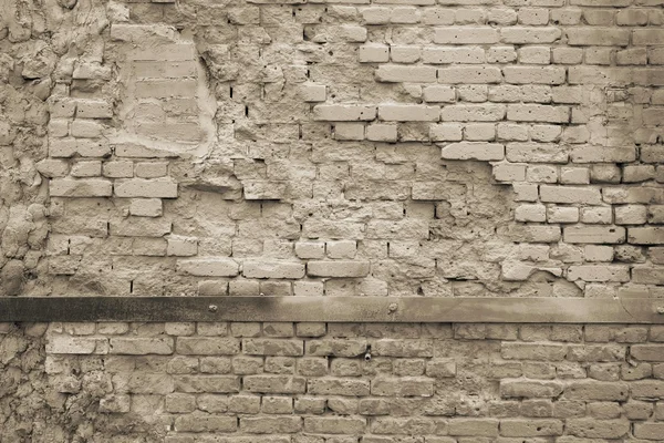 Бежевая текстура разрушенной кирпичной стены — стоковое фото