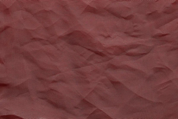 crumpled mesh synthetic fabric of crimson color