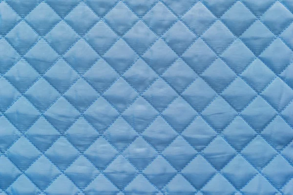 Blue quilted synthetic fabric with grained texture Εικόνα Αρχείου