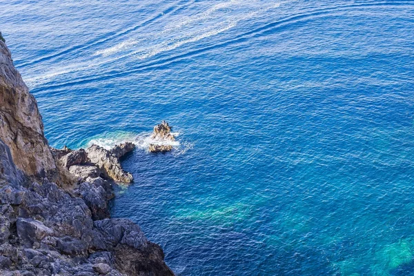 Costa rocosa gris y mar u océano azul — Foto de Stock