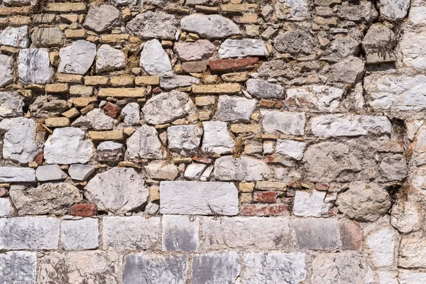 破壊された石の壁の古い抽象的なテクスチャ — ストック写真